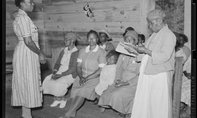 Juanita Coleman listening to one of her pupils read in her adult class