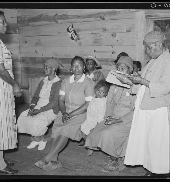 Juanita Coleman listening to one of her pupils read in her adult class