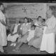 Juanita Coleman listening to one of her pupils read in her adult class